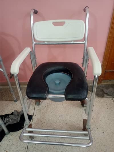 4 in 1 commode wheel chair with a Chrome frame and wheel