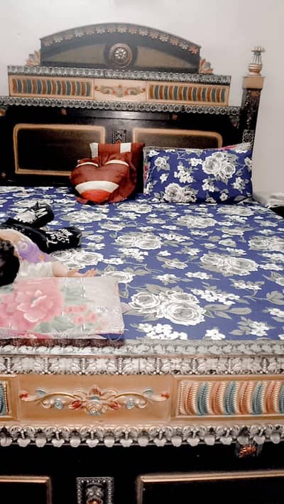 bed with side table showcases and dressing table