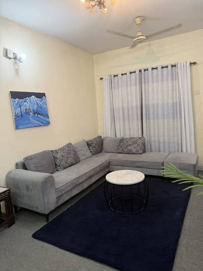 L shaped sofa and blue rug for sale