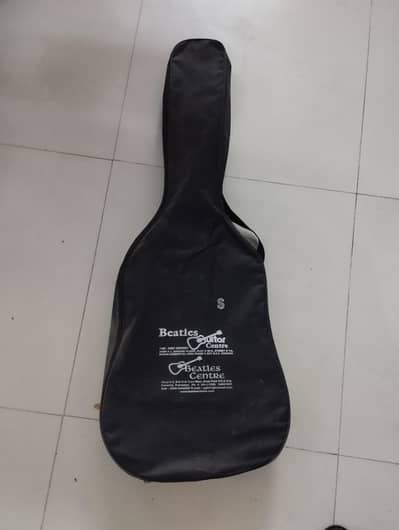 brand new acoutic guitar by Beatles with capo