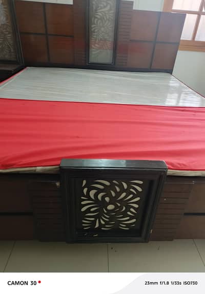 two double beds with side tables and dressing