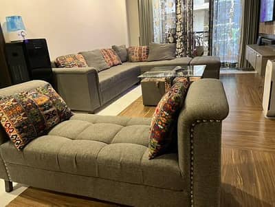 L shaped sofa set with center table a foot rest and dewaan