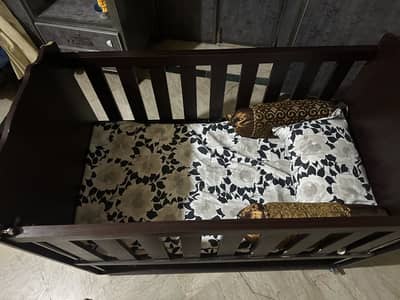 Wooden baby cot with mattress