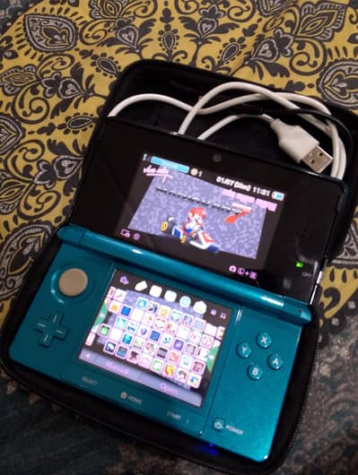 Nintendo 3DS modded with accessories and a charger