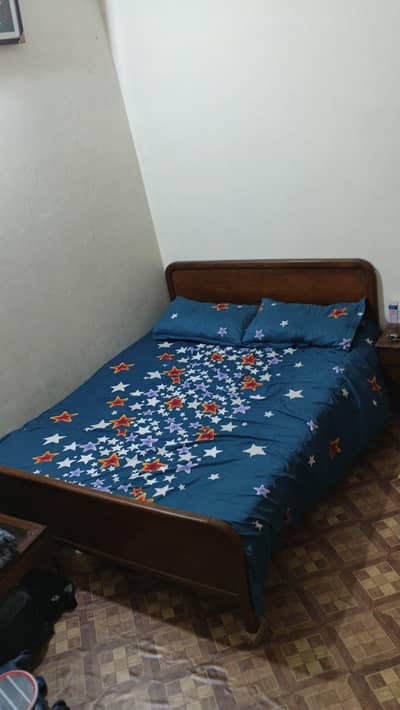 Wooden double bed in very good condition .