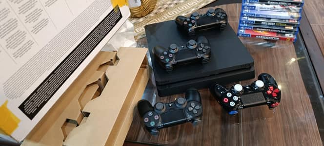 PS4 with 4 controllers and 7 games for sale -,033.96.96. 9,606