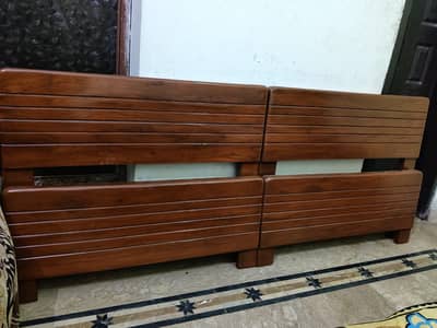 2 wooden single beds