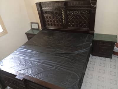 king bed with 2 side tables and 1 big mirror dressing table