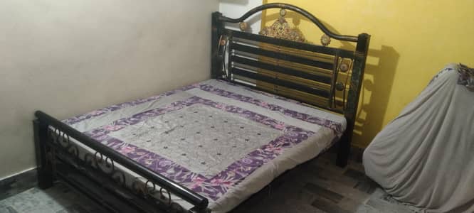 black iron bed with mattress