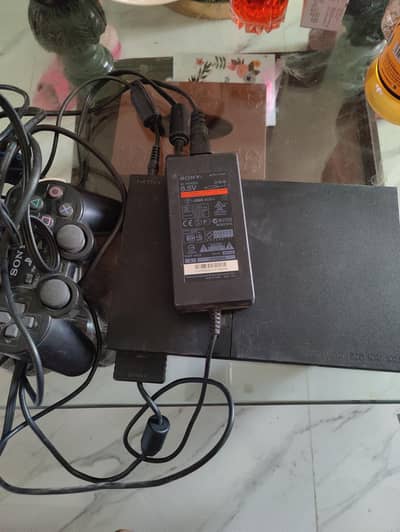 playstation 2 with controllers and original games