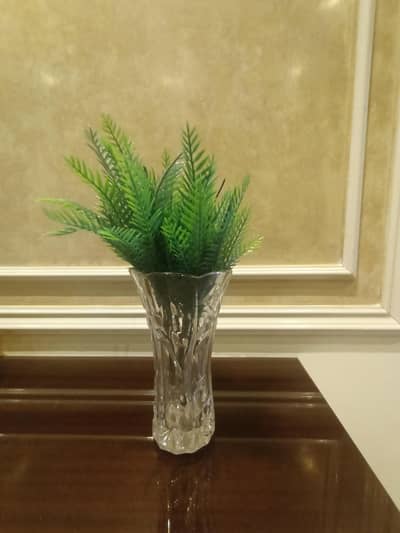 white glass vase with leaves