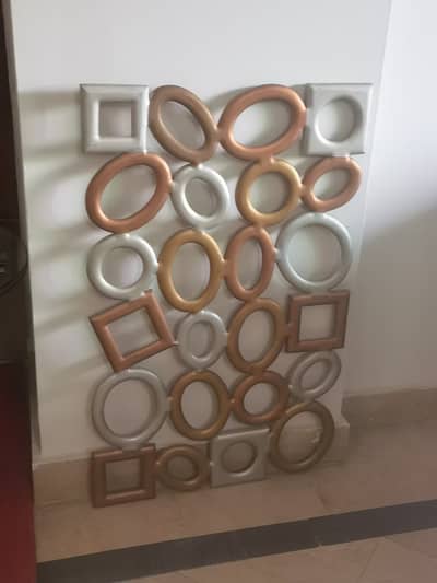 Wall hanging that can be used as a frame for small portraits