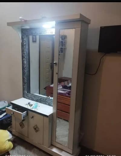 Dressing table with makeup portion behind mirror