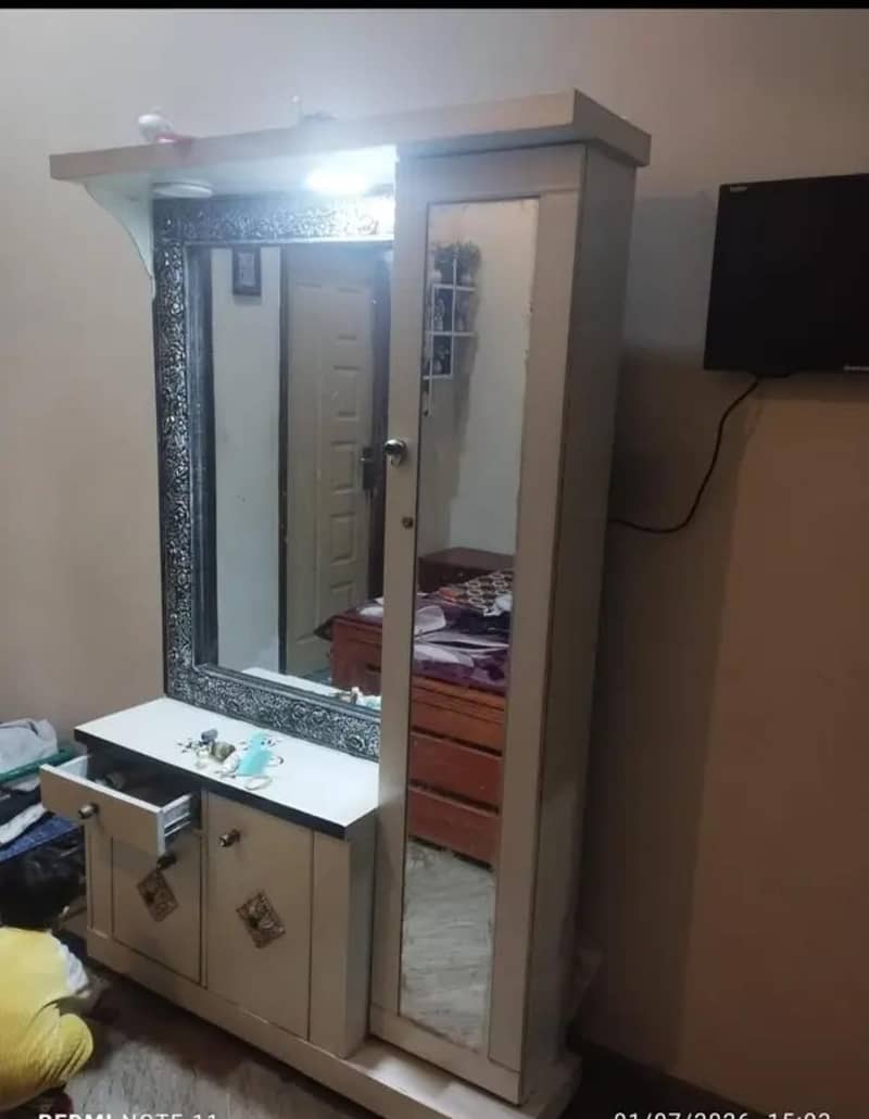 Dressing table with makeup portion behind mirror 1