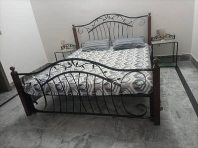 heavy stee bed with side tables along with mattres
