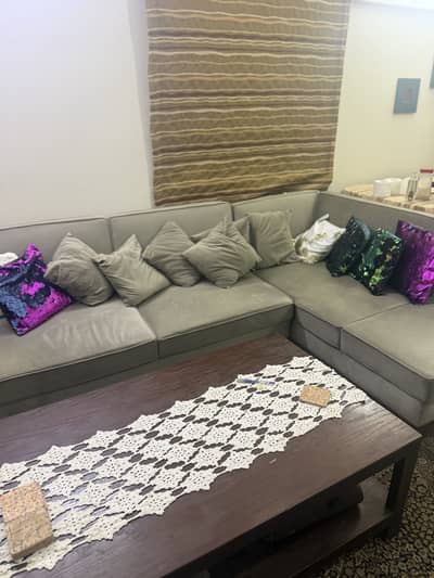 Habit branded L-shaped drawing room sofa with ash brown table