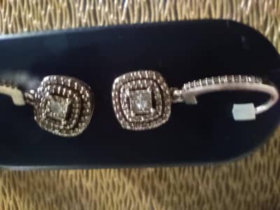 silver earrings and locket with tiny diamond decoration