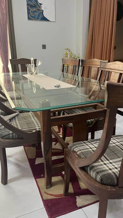 8 seated wooden dining table with glass top