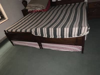 Two single, pure Sheesham wood beds with brand new foam mattress.