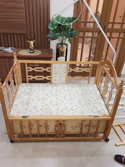 Baby cot with wooden swing with mattress.