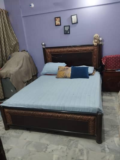 Pure wooden bed with iron rods