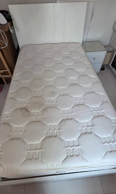branded single bed with mattress and side table