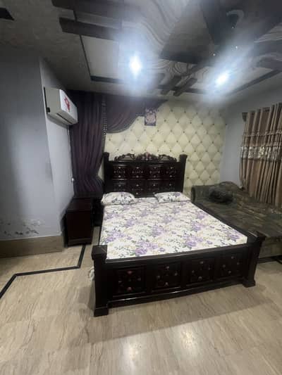 Wooden bed with side table and dressing