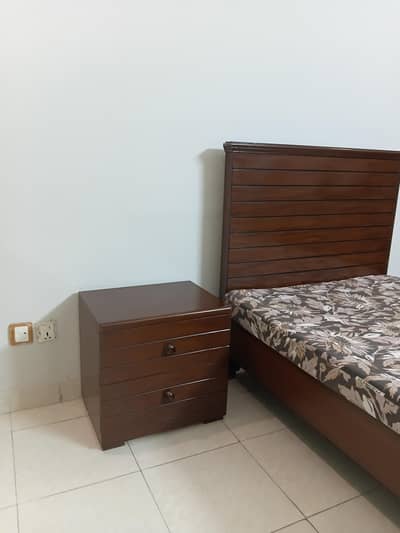 single bed with side table