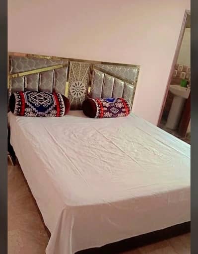 wooden bed and alamri without maters