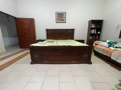 wooden bed with side table