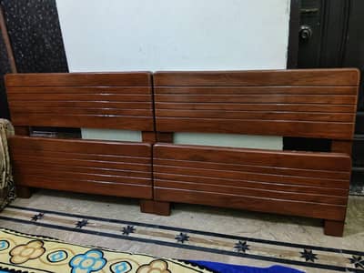 2 wooden single beds
