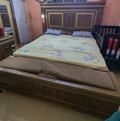 king size bed with side table and dressing table