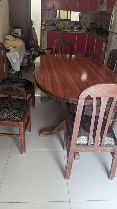 big wooden dining table with 6 wooden chairs