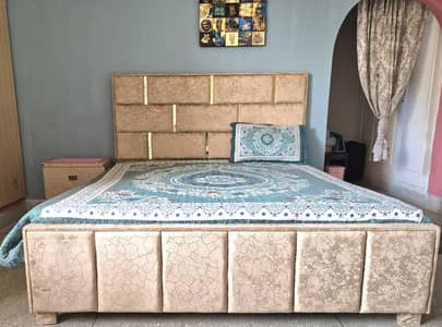 Double bed with mattress and side table