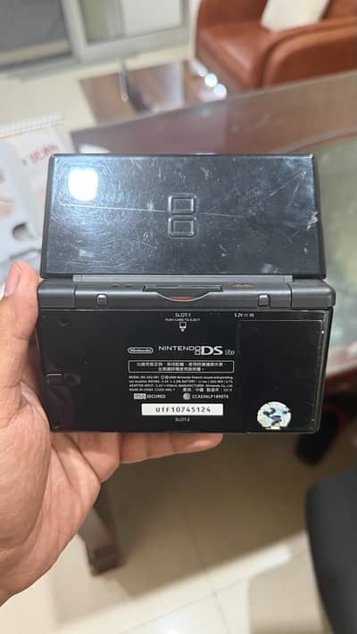 Nintendo DS lite with storage card and original charger