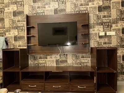 Modern wall mounted TV unit with storage drawers and side shelves: