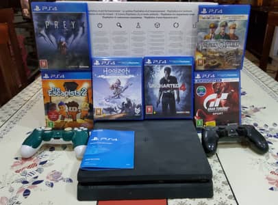 PS4 Slim with 2 original controllers and 6 disc games