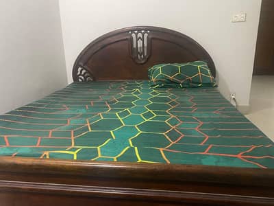 Used wooden bed without mattress