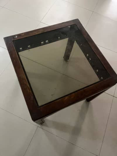 2 wooden coffee tables along with an antique glass jar