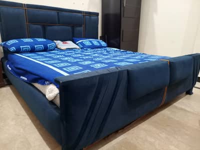 Wooden cushioned bed with mattress. 03323264556