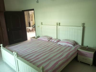 2 wooden beds with side tables for sale
