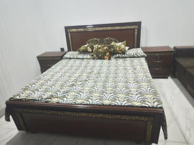 wooden bed with side tables and mattress