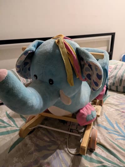 Baby elephant rocking with tire chair