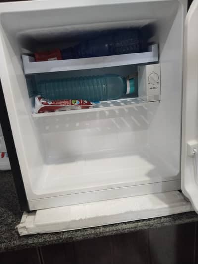 New Haire Mini Refrigerator with 1 year warranty card. Model HR66B