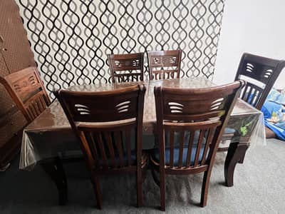 Wooden dining table with six chairs