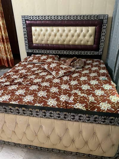 wooden bed with dressing table and one side table