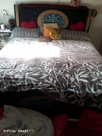 black wooden bed  with side table