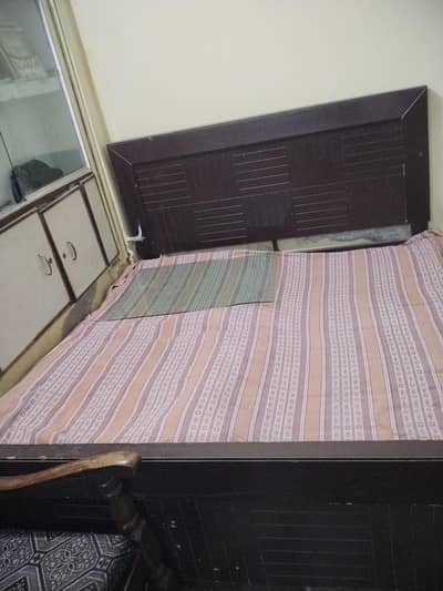 wooden bed with side tables and singhar table