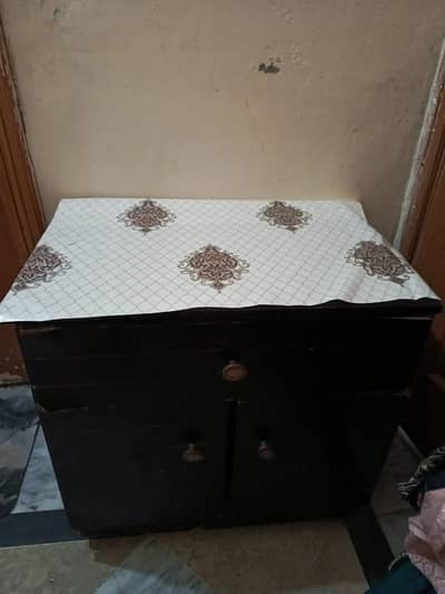 King size bed with two side tables and a dressing table