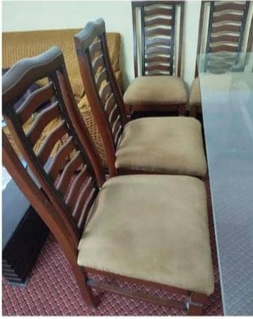 6 seater wooden dining table with glass top and cushion chairs